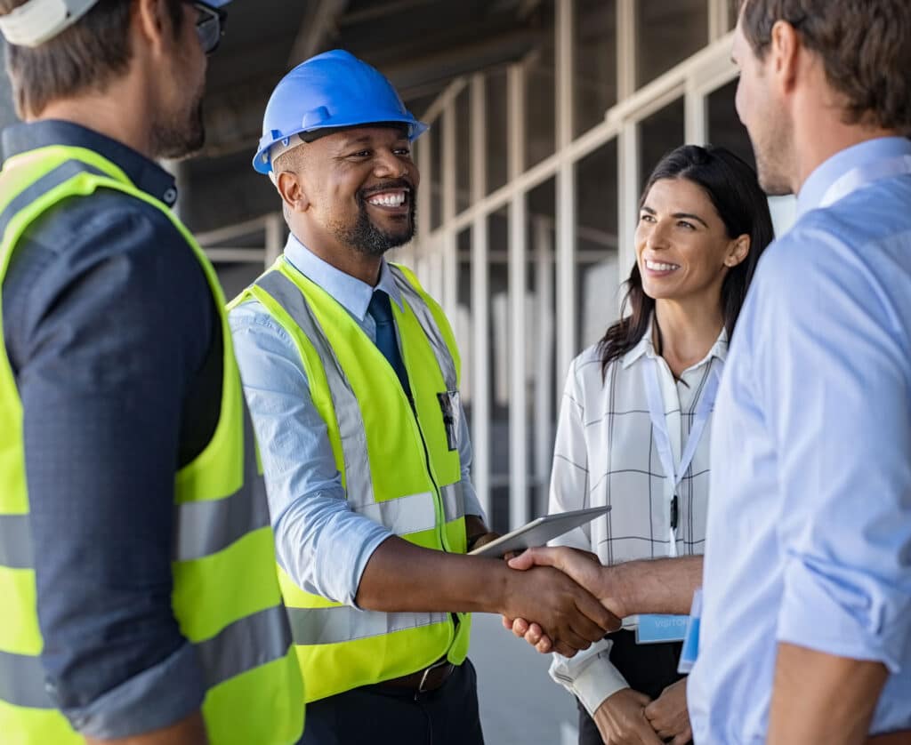 Engineer and manager handshake at construction site