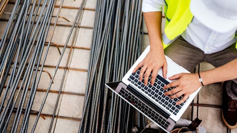 Engineer using laptop on construction site